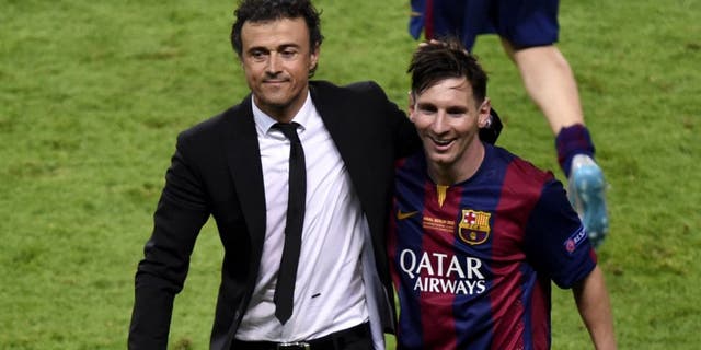 Barcelona's coach Luis Enrique and Barcelona's Argentinian forward Lionel Messi (R) celebrate after winning the UEFA Champions League Final football match between Juventus and FC Barcelona at the Olympic Stadium in Berlin on June 6, 2015. AFP PHOTO / ODD ANDERSEN (Photo credit should read ODD ANDERSEN/AFP/Getty Images)