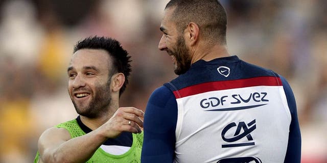 France's midfielder Mathieu Valbuena (L) talks to France's forward Karim Benzema during a training session at the Santa Cruz Stadium in Ribeirao Prato on June 10, 2014, a few days prior to the start of the 2014 FIFA World Cup in Brazil. AFP PHOTO / FRANCK FIFE (Photo credit should read FRANCK FIFE/AFP/Getty Images)
