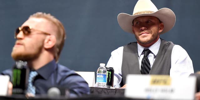 LAS VEGAS, NEVADA - SEPTEMBER 04: (R-L) UFC lightweight title challenger Donald 'Cowboy' Cerrone exchanges words with UFC interim featherweight champion Conor McGregor during the UFC's Go Big launch event inside MGM Grand Garden Arena on September 4, 2015 in Las Vegas, Nevada. (Photo by Jeff Bottari/Zuffa LLC/Zuffa LLC via Getty Images)