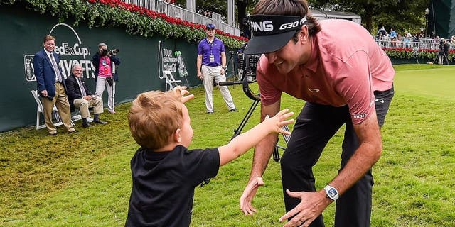 ATLANTA, GA - SEPTEMBER 27: Bubba Watson hugs his son Caleb on the 18th hole green following the final round of the TOUR Championship by Coca-Cola, the final event of the FedExCup Playoffs, at East Lake Golf Club on September 27, 2015 in Atlanta, Georgia. (Photo by Stan Badz/PGA TOUR)