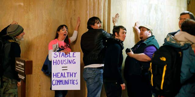Feb. 18, 2016: Protesters pound on the walls outside of the House Chamber in the Capitol Building, in Salem , Ore.