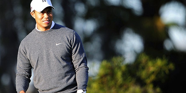 File: Tiger Woods practices golf outside his home in Windermere, Fla.