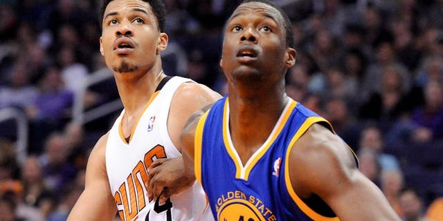Feb 8, 2014; Phoenix, AZ, USA; Phoenix Suns guard Gerald Green (14) and Golden State Warriors forward Harrison Barnes (40) battle for positioning during the third quarter at US Airways Center. The Suns won 122-109. Mandatory Credit: Casey Sapio-USA TODAY Sports