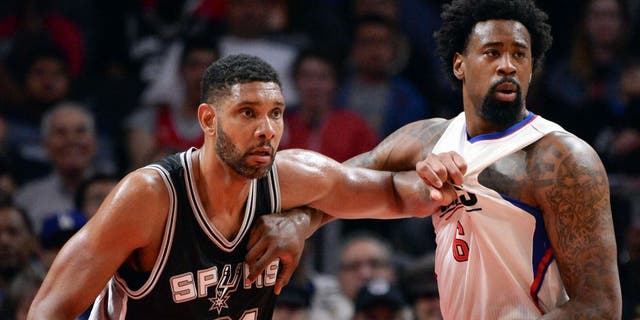 Feb 18, 2016; Los Angeles, CA, USA; San Antonio Spurs center Tim Duncan (21) and Los Angeles Clippers center DeAndre Jordan (6) jostle for position on the baseline during the 2nd half at Staples Center. Mandatory Credit: Robert Hanashiro-USA TODAY Sports