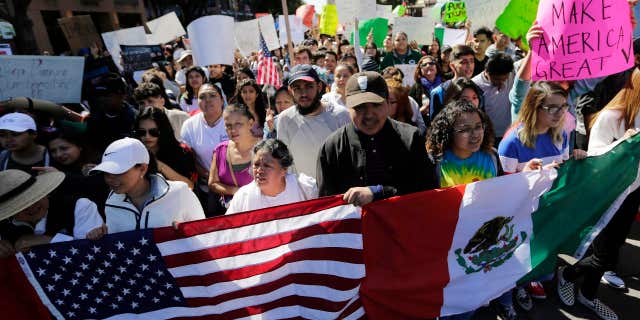 A group marches through downtown heading to the Texas Capitol during an immigration protest, Thursday, Feb. 16, 2017, in Austin, Texas.