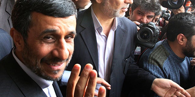Feb. 20: Iranian President Mahmoud Ahmadinejad waves to the media as he leaves the parliament in Tehran.