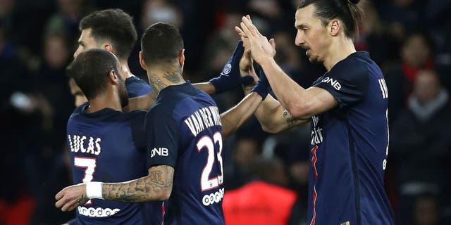 Paris Saint-Germain's Swedish forward Zlatan Ibrahimovic (R) celebrates with teammates after scoring a goal during the French L1 football match between Paris Saint-Germain (PSG) and Reims at the Parc des Princes stadium in Paris on February 20, 2016. AFP PHOTO / THOMAS SAMSON / AFP / THOMAS SAMSON (Photo credit should read THOMAS SAMSON/AFP/Getty Images)