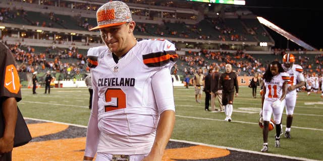 FILE- In this Nov. 5, 2015, file photo, Cleveland Browns quarterback Johnny Manziel walks off the field after the Browns lost 31-10 to the Cincinnati Bengals during an NFL football game in Cincinnati.