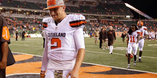 FILE- In this Nov. 5, 2015, file photo, Cleveland Browns quarterback Johnny Manziel walks off the field after the Browns lost 31-10 to the Cincinnati Bengals during an NFL football game in Cincinnati.