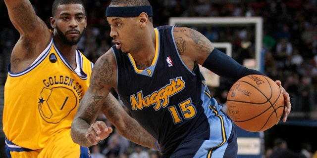 Feb. 9: Denver Nuggets forward Carmelo Anthony (15) drives against Golden State Warriors forward Dorell Wright (1) in the first quarter of an NBA basketball game in Oakland, Calif.