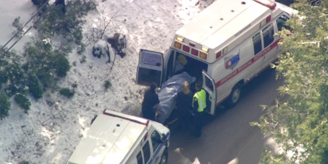 Feb. 21: An injured victim from a school bus accident is loaded into the back of an ambulance.
