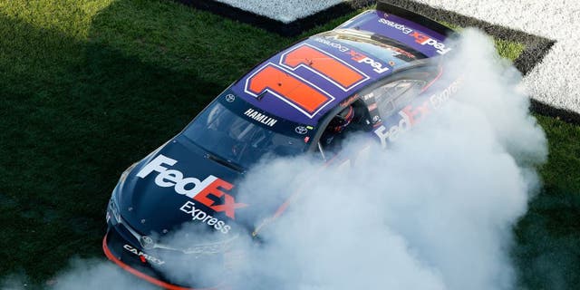DAYTONA BEACH, FL - FEBRUARY 21: Denny Hamlin, driver of the #11 FedEx Express Toyota, celebrates with a burnout after winning the NASCAR Sprint Cup Series DAYTONA 500 at Daytona International Speedway on February 21, 2016 in Daytona Beach, Florida. (Photo by Brian Lawdermilk/Getty Images)