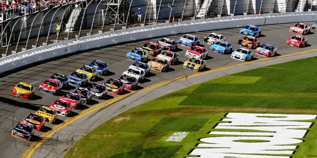 DAYTONA BEACH, FL - FEBRUARY 21: Denny Hamlin, driver of the #11 FedEx Express Toyota, leads the field during the NASCAR Sprint Cup Series DAYTONA 500 at Daytona International Speedway on February 21, 2016 in Daytona Beach, Florida. (Photo by Jerry Markland/Getty Images)