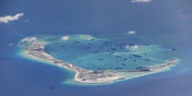 May 21, 2015: Chinese dredging vessels are purportedly seen in the waters around Mischief Reef in the disputed Spratly Islands in the South China Sea in this still image from video taken by a P-8A Poseidon surveillance aircraft.