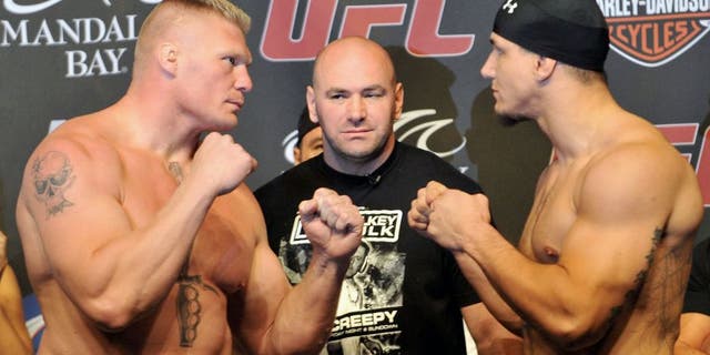 LAS VEGAS - JULY 10: UFC heavyweight fighters Brock Lesnar (L) and Frank Mir (R) square off at UFC 100 Weigh-Ins at the Mandalay Bay Hotel and Casino on July 10, 2009 in Las Vegas, Nevada. (Photo by Jon Kopaloff/Getty Images)