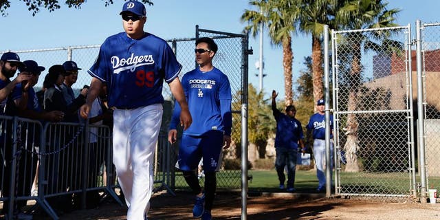 GLENDALE, AZ - FEBRUARY 20: Starting pitcher Hyun-Jin Ryu #99 of the Los Angeles Dodgers arrives to a spring training workout at Camelback Ranch on February 20, 2016 in Glendale, Arizona. (Photo by Christian Petersen/Getty Images)