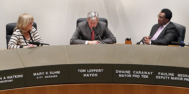Feb. 23: Dallas City Manager Mary Suhm, left, and Dallas Mayor Pro Tem Dwaine Caraway, right, listen as Dallas Mayor Tom Leppert pauses during his resignation address.