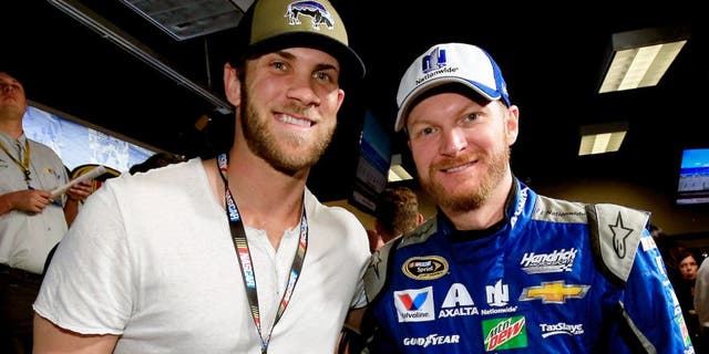 DAYTONA BEACH, FL - FEBRUARY 21: Bryce Harper poses with Dale Earnhardt Jr., driver of the #88 Nationwide Chevrolet at the driver's meeting prior to the NASCAR Sprint Cup Series DAYTONA 500 at Daytona International Speedway on February 21, 2016 in Daytona Beach, Florida. (Photo by Chris Trotman/NASCAR via Getty Images)