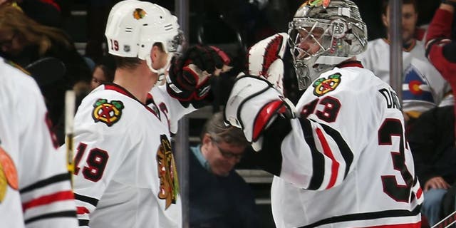 NEWARK, NJ - DECEMBER 09: Jonathan Toews #19 and Scott Darling #33 of the Chicago Blackhawks celebrate a 3-2 shootout victory over the New Jersey Devils at the Prudential Center on December 9, 2014 in Newark, New Jersey. (Photo by Bruce Bennett/Getty Images)