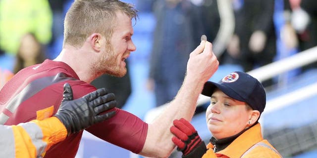 READING, ENGLAND - FEBRUARY 20: Chris Brunt of West Bromwich Albion is held back by stewards as he holds up the coin that was thrown at him by his own supporters after the Emirates FA Cup match between Reading and West Bromwich Albion at Madejski Stadium on February 20, 2016 in Reading, England. (Photo by Adam Fradgley - AMA/ Getty Images)