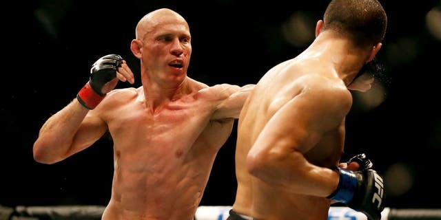 LAS VEGAS, NV - MAY 23: (L-R) Donald Cerrone punches John Makdessi of Canada in their lightweight bout during the UFC 187 event at the MGM Grand Garden Arena on May 23, 2015 in Las Vegas, Nevada. (Photo by Christian Petersen/Zuffa LLC/Zuffa LLC via Getty Images)