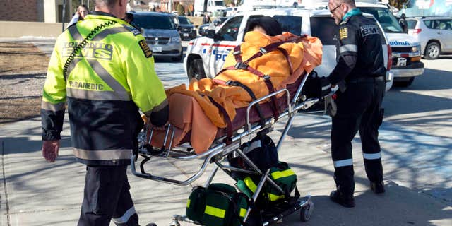 Feb. 24, 2016: An unidentified victim is taken away on a stretcher by emergency personnel remove following a stabbing incident at Dunbarton High School in Pickering, Ontario.