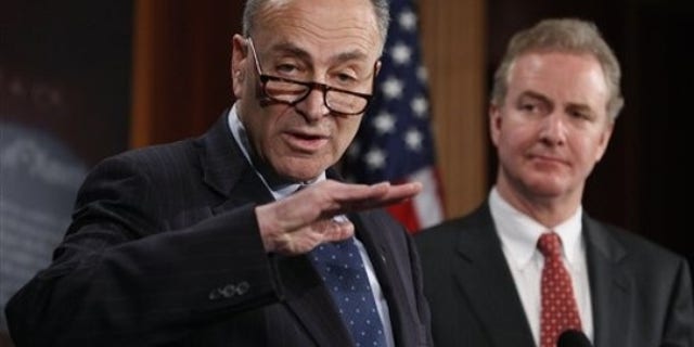 Sen. Charles Schumer, D-N.Y., left, accompanied by Rep. Chris Van Hollen, D-Md., gestures during a news conference introducing a bill to undo the Supreme Court's Citizens United ruling, Thursday, Feb. 11, 2010, on Capitol Hill in Washington. (AP Photo/Manuel Balce Ceneta)