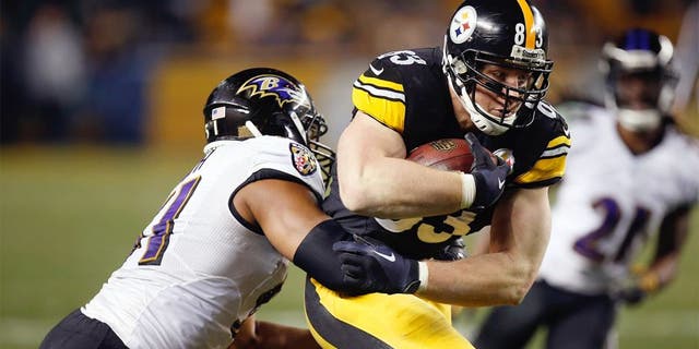 PITTSBURGH, PA - JANUARY 03: Heath Miller #83 of the Pittsburgh Steelers is tackled by Daryl Smith #51 of the Baltimore Ravens during their AFC Wild Card game at Heinz Field on January 3, 2015 in Pittsburgh, Pennsylvania. (Photo by Gregory Shamus/Getty Images)