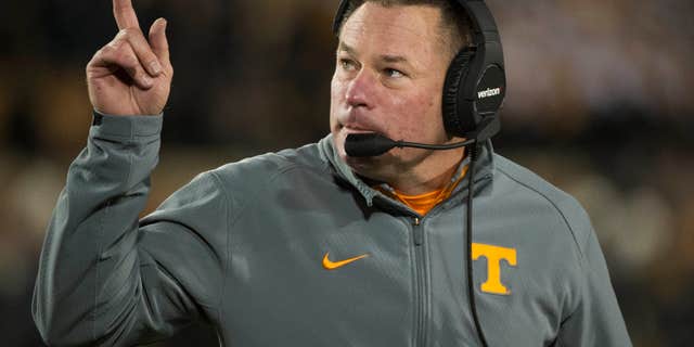 FILE - In this Nov. 21, 2015 file photo, Tennessee head coach Butch Jones points to the scoreboard during the first quarter of an NCAA college football game against Missouri in Columbia, Mo.
