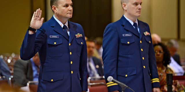 Feb. 24, 2016: OS2 Matthew Chancery, left, U.S. Coast Guard District 7, is sworn in to start the day while standing next to his counsel Lt. Travis Noyes as a U.S. Coast Guard investigative hearing into the sinking of the El Faro continues in Jacksonville, Fla..