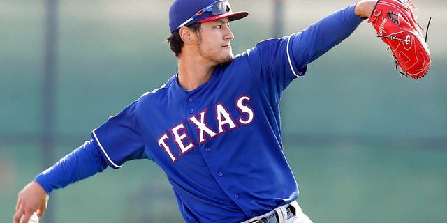 Feb 24, 2015; Surprise, AZ, USA; Texas Rangers starting pitcher Yu Darvish (11) warms up during spring training camp at Surprise Stadium. Mandatory Credit: Rick Scuteri-USA TODAY Sports