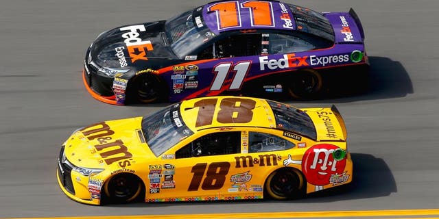 DAYTONA BEACH, FL - FEBRUARY 21: Kyle Busch, driver of the #18 M&M's 75 Toyota, races Denny Hamlin, driver of the #11 FedEx Express Toyota, during the NASCAR Sprint Cup Series DAYTONA 500 at Daytona International Speedway on February 21, 2016 in Daytona Beach, Florida. (Photo by Jonathan Ferrey/Getty Images)