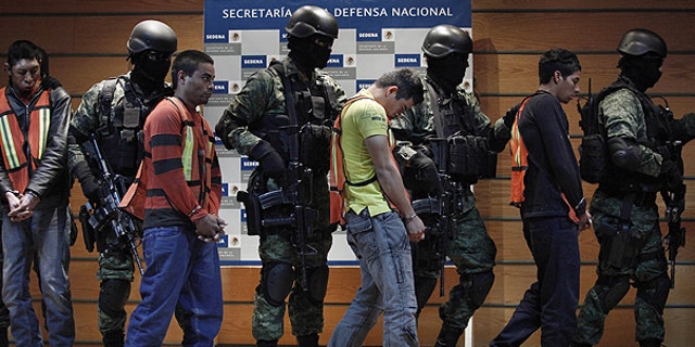 Feb. 23: Soldiers escort Julian Zapata Espinosa, aka 'El Piolin,' fourth right, alleged member of the Los Zetas drug cartel and main suspect in the killing of U.S. Immigration and Customs, ICE, agent Jaime Zapata.