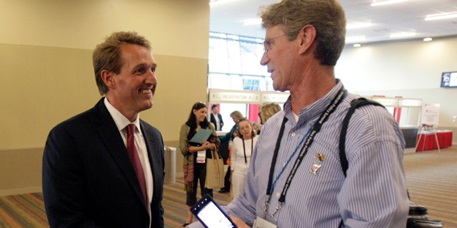 Feb. 25: Rep. Jeff Flake (R-Ariz.), left, is greeted by Marcus Huey, right, of Tea Party Patriots of Glendale, Ariz., as Flake arrives to hear keynote speakers on the opening day of the Tea Party's convention.