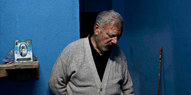 Egyptian Christian Ezzat Yaacoub Ishak, who fled el-Arish in North Sinai with his family two days ago due to fighting, stands in his newly rented apartment, in Ismailia, 120 kilometers (75 miles) east of Cairo, Egypt, Sunday, Feb. 26, 2017.