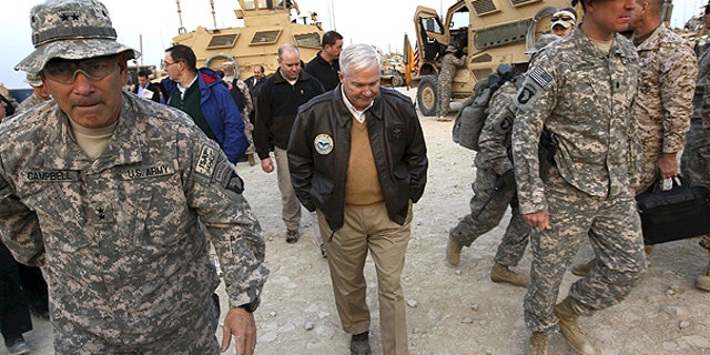 In this Dec. 7, 2010 file photo, Defense Secretary Robert Gates walks with Maj. Gen. John Campbell, left,, commanding general of the 101st Air Assault, in Kunar Province, Afghanistan.