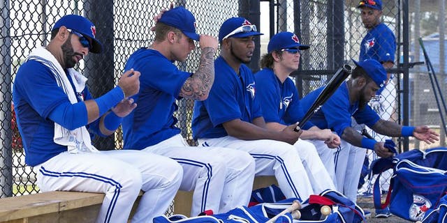 Toronto Blue Jays, from left, Jose Bautista, Brett Lawrie, Edwin Encarnacion, Colby Rasmus and Jose Reyes prepare for an intrasquad game at baseball spring training in Dunedin, Fla., Tuesday, Feb. 25, 2014. (AP Photo/The Canadian Press, Frank Gunn)
