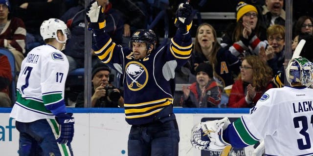 Feb 26, 2015; Buffalo, NY, USA; Buffalo Sabres right wing Brian Gionta (12) celebrates the goal by defenseman Andrej Meszaros (41) (not shown) during the third period at First Niagara Center. Sabres beat the Canucks 6-3. Mandatory Credit: Kevin Hoffman-USA TODAY Sports