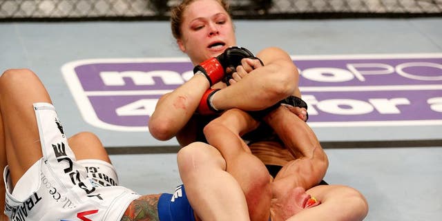 ANAHEIM, CA - FEBRUARY 23: Ronda Rousey (black shorts) secures an arm bar submission against Liz Carmouche in their women's bantamweight title fight during UFC 157 at Honda Center on February 23, 2013 in Anaheim, California. (Photo by Josh Hedges/Zuffa LLC/Zuffa LLC via Getty Images) *** Local Caption *** Ronda Rousey; Liz Carmouche