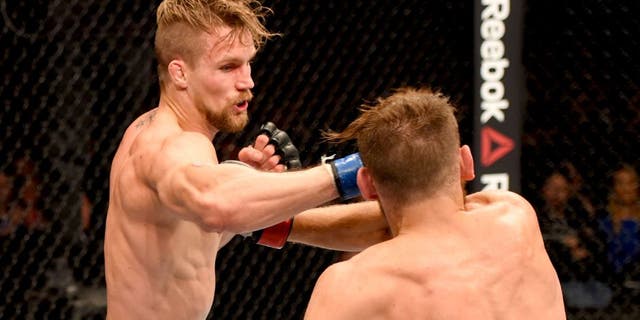 GLASGOW, SCOTLAND - JULY 18: (L-R) Teemu Packalen of Finland punches Mickael Lebout of France in their lightweight fight during the UFC Fight Night event inside the SSE Hydro on July 18, 2015 in Glasgow, Scotland. (Photo by Josh Hedges/Zuffa LLC/Zuffa LLC via Getty Images)