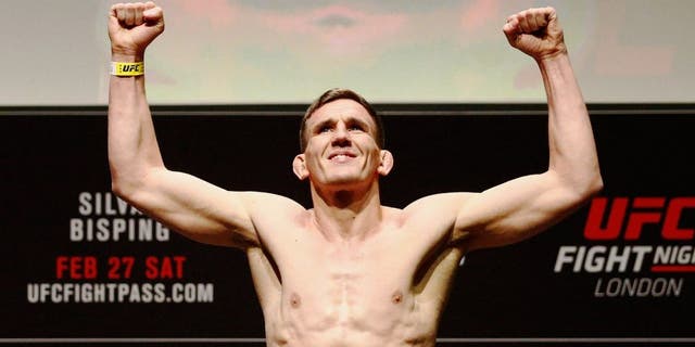 LONDON, ENGLAND - FEBRUARY 26: Scott Askham of England poses on the scales on stage during the UFC Fight Night Weigh-in held at at Indigo at The O2 Arena on February 26, 2016 in London, England. Scott Askham (L) of England and Chris Dempsey (R) of the USA will fight tomorrow night in the O2 Arena. (Photo by Dean Mouhtaropoulos/Zuffa LLC/Zuffa LLC via Getty Images)