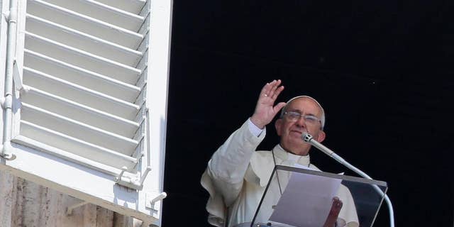 Pope Francis delivers a blessing during the Angelus noon prayer he delivered from his studio's window, in St. Peter's Square, at the Vatican, Sunday, July 19, 2015. Speaking from his studio window, Francis told the crowd Sunday in St. Peter's Square: "I see you are courageous with this heat in the square. A tip of the hat to you!" Many faithful used sun umbrellas. Temperatures in Rome this week could hit 38-39C (100-102F). Sizzling heat and oppressive humidity have gripped Italy this month, with some nights in Rome seeing "low" temperatures hovering near 30C (86F). (AP Photo/Gregorio Borgia)