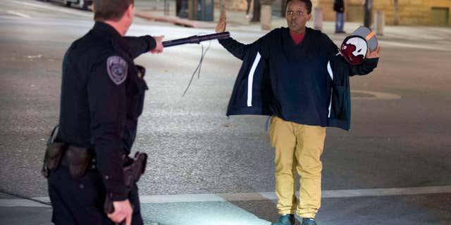 Feb. 27, 2016: Police stop a boy as he walks away from a crowd that formed after an officer-involved shooting at 200 South Rio Grande Street in Salt Lake City.