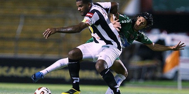 Aug. 4, 2010: s Tauro fights for the ball with Randy Diamond Honduras's Marathon during their CONCACAF Champions League soccer match in San Pedro Sula.