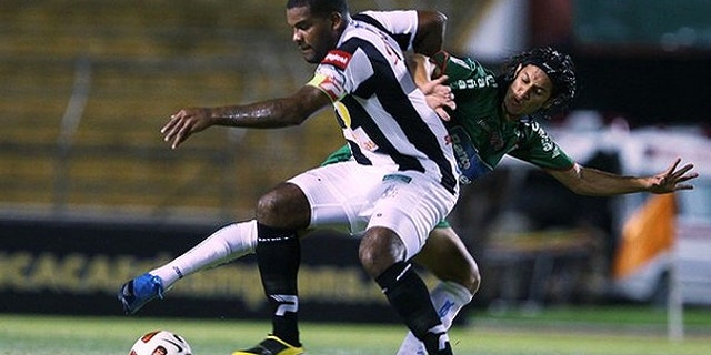 Aug. 4, 2010: s Tauro fights for the ball with Randy Diamond Honduras's Marathon during their CONCACAF Champions League soccer match in San Pedro Sula.