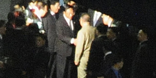 Aug. 28: A man, believed to be North Korean leader Kim Jong Il, center facing away from camera, is greeted at Changchun rail station in Changchun, China.
