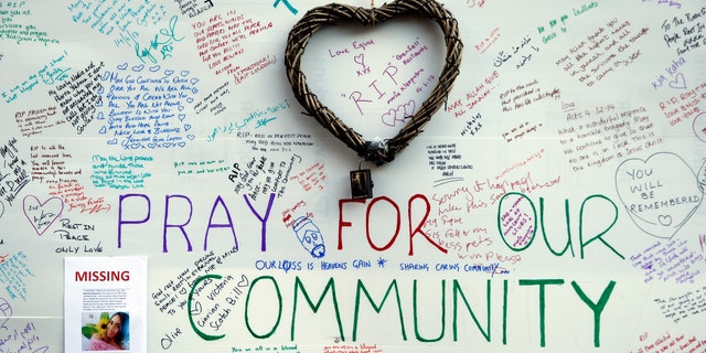 Messages of support for those affected by the massive fire in Grenfell Tower are displayed on a well near the tower in London, Thursday, June 15, 2017. A massive fire raced through the 24-story high-rise apartment building in west London early Wednesday. (AP Photo/Alastair Grant)