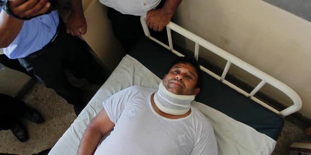 Sri Lanka's ruling United National Party lawmaker Sandith Samarasinghe lies on a hospital bed in Colombo, Sri Lanka, Tuesday, May 3, 2016. Samarasinghe was hospitalized and several lawmakers were injured in fisticuffs inside Sri Lanka's Parliament after a protest over the removal of military security for former President Mahinda Rajapakasa.(AP Photo/Eranga Jayawardena)