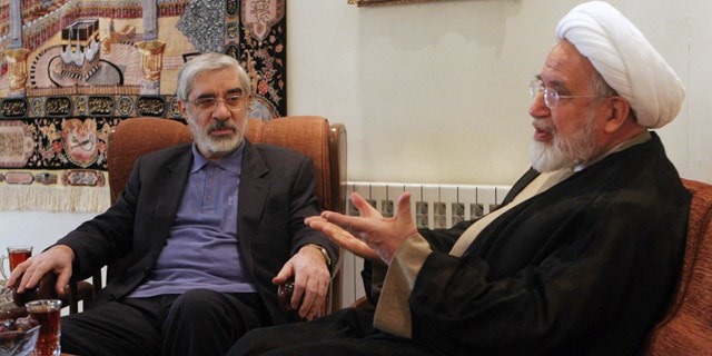 In this Saturday, Oct. 10, 2009, file photo, leaders of Iranian opposition, Mahdi Karroubi, right, and Mir Hossein Mousavi talk in Tehran, Iran.