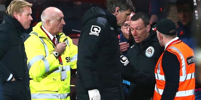 BOURNEMOUTH, ENGLAND - MARCH 01: Blooded fourth official Kevin Friend receives treatment by team staffs during the Barclays Premier League match between A.F.C. Bournemouth and Southampton at Vitality Stadium on March 1, 2016 in Bournemouth, England. (Photo by Michael Steele/Getty Images)